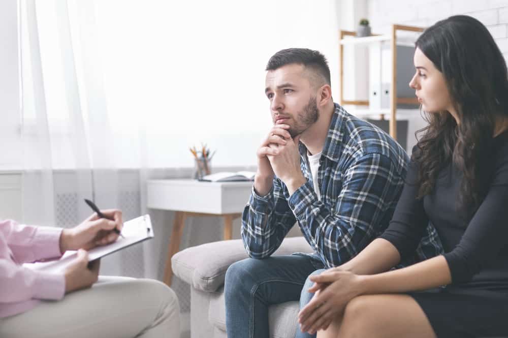 Young grumpy couple at marital counseling therapy